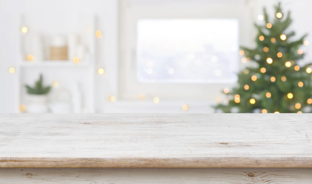 Table space in front of defocused window sill with Christmas tree